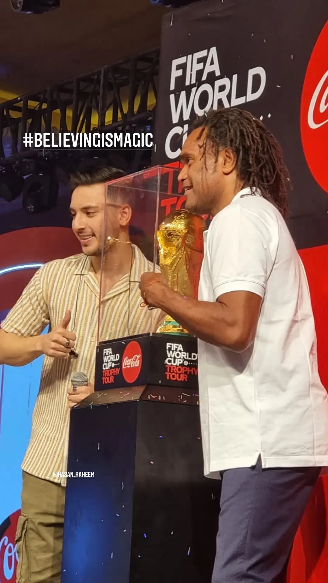 Guests holding the trophy at the Coca-Cola event