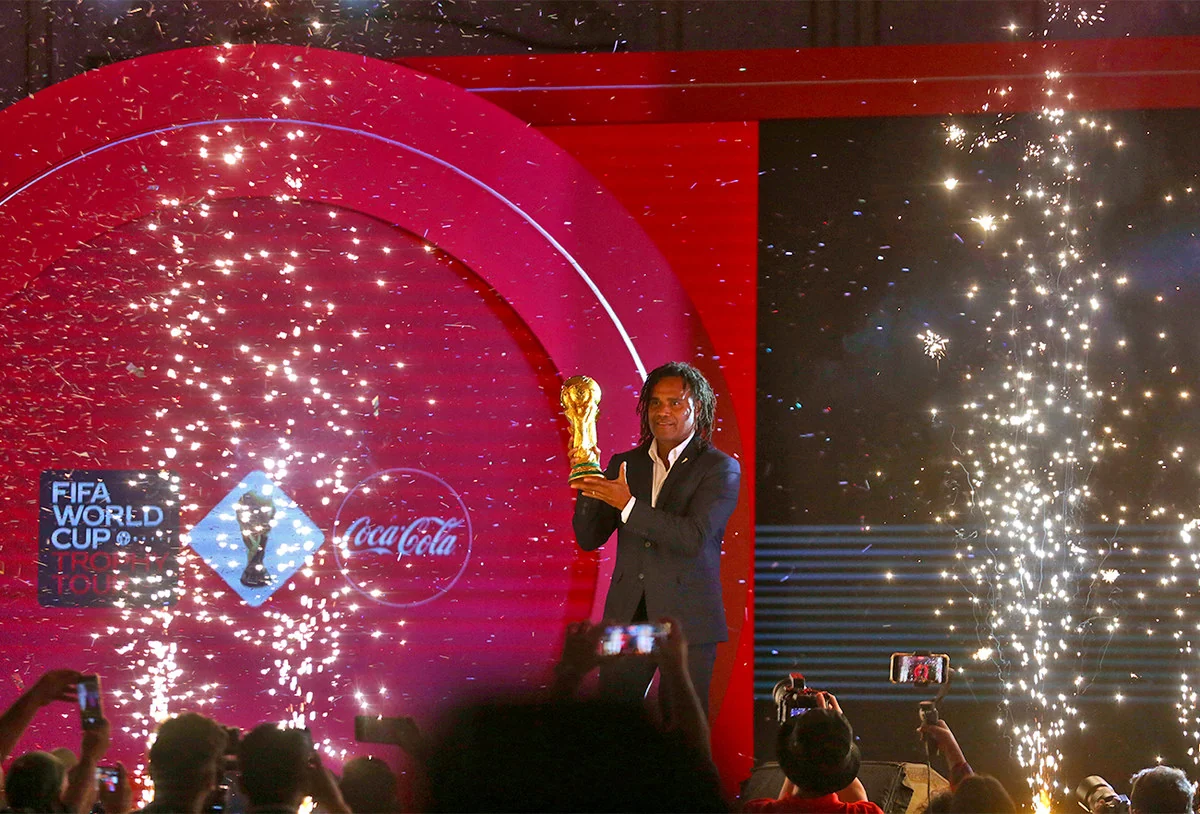 Trophy presentation on a red Coca-Cola event stage