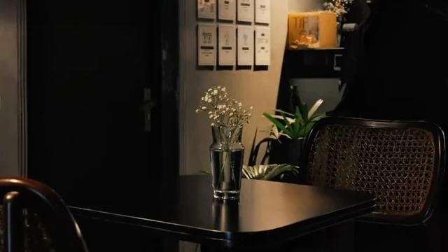 KAFI’s warmly lit café interior with branded stationery and a black coffee cup.